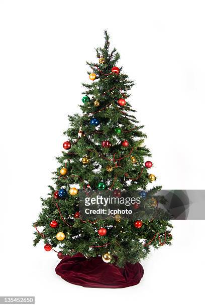 christmas tree with colored ornaments and burgundy skirt - christmas tree white background stock pictures, royalty-free photos & images