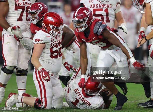 Dallas Turner and Will Anderson Jr. #31 of the Alabama Crimson Tide reacts sacking KJ Jefferson of the Arkansas Razorbacks during the second half at...