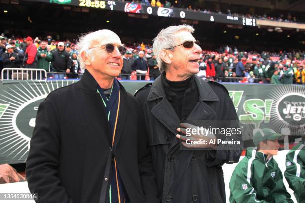 Actor Larry David and Richard Belzer share a laugh on the New York Jets sideline before the Buffalo Bills vs New York Jets game at Giants Stadium on...