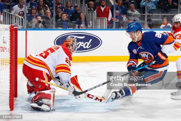 Jacob Markstrom of the Calgary Flames makes the second period stop on Oliver Wahlstrom of the New York Islanders at the UBS Arena on November 20,...