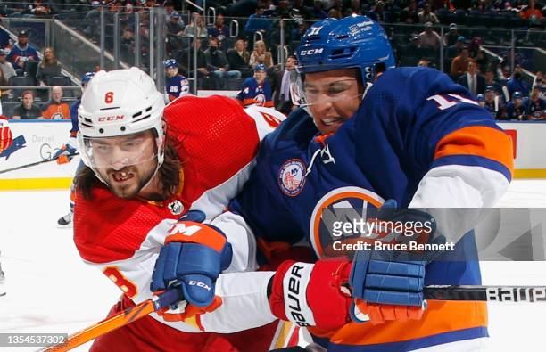 Christopher Tanev of the Calgary Flames and Zach Parise of the New York Islanders battle for position during the second period at the UBS Arena on...