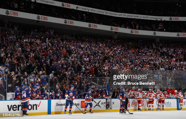 Fans celebrate a first period goal by Brock Nelson of the New York Islanders, the first in the new building against the Calgary Flames at the UBS...