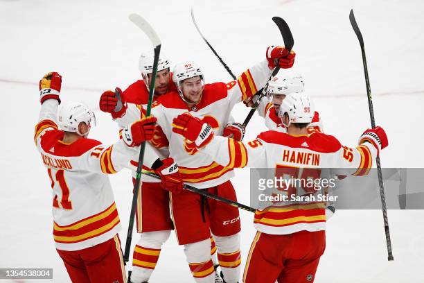 Andrew Mangiapane of the Calgary Flames reacts with Mikael Backlund, Milan Lucic and Noah Hanifin after scoring a goal during the second period...