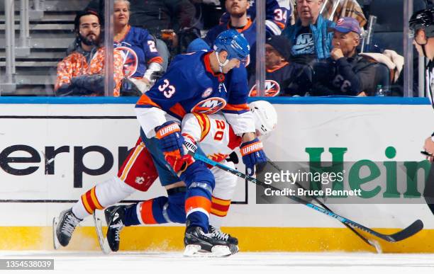Zdeno Chara of the New York Islanders checks Blake Coleman of the Calgary Flames during the second period at the UBS Arena on November 20, 2021 in...