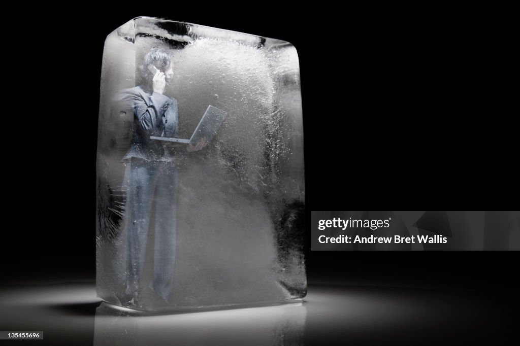 Frozen businesswoman with laptop & mobile