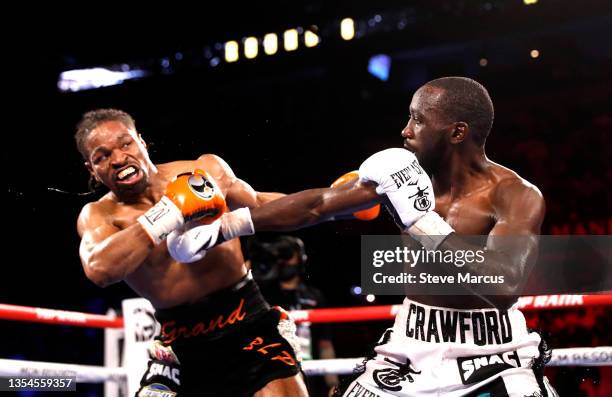 Champion Terence Crawford punches Shawn Porter during their welterweight title fight at Michelob ULTRA Arena on November 20, 2021 in Las Vegas,...