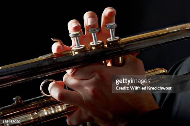 trumpet with fingers on keys, close-up - tromba foto e immagini stock