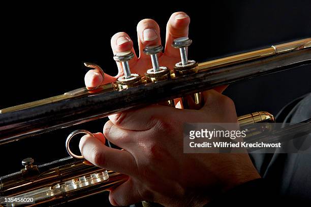 trumpet with fingers on keys, close-up - trumpet stock pictures, royalty-free photos & images