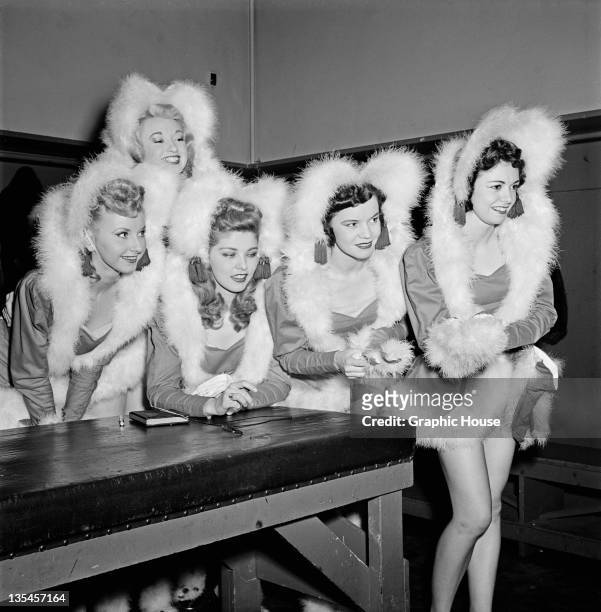 Members of The Rockettes precision dance company backstage at the Radio City Music Hall in Manhattan, New York City, circa 1950. They are wearing...