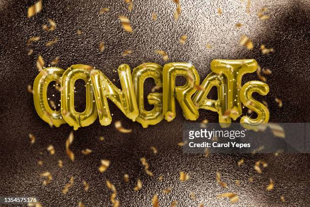 congrats text with golden confetti golden foil balloon - congratulating 個照片及圖片檔