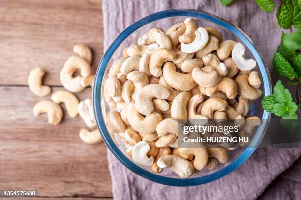 cashew nuts on wooden background, top view - cashew ストックフォトと画像