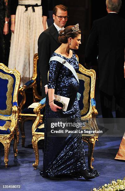 Prince Daniel of Sweden smiles as his pregnant wife, Crown Princess Victoria of Sweden, at the Nobel Prize Award Ceremony 2011 at Stockholm Concert...