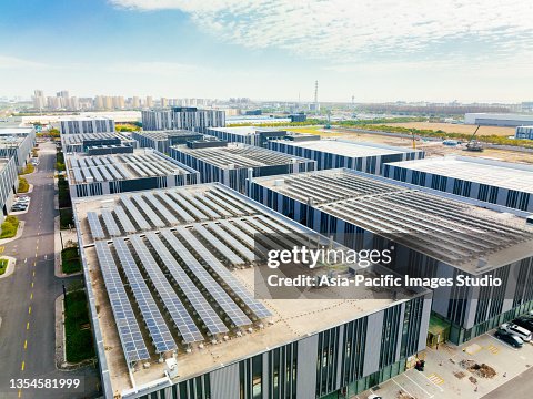 Aerial view of solar panels on factory roof. Blue shiny solar photo voltaic panels system product. Aerial view of solar panels on factory roof. Blue shiny solar photo voltaic panels system product.