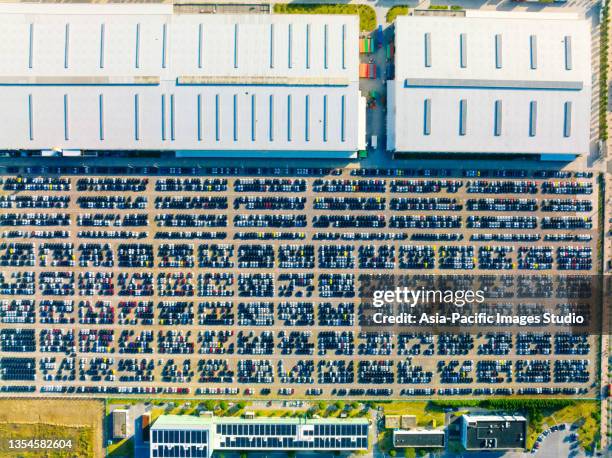 aerial view of rows of cars parked on parking lot. new cars dealer inventory import export business commercial global, automobile and automotive industry distribution logistic transport worldwide. - docklands studio stock pictures, royalty-free photos & images