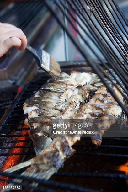 fish on a restaurant grill - basted stock pictures, royalty-free photos & images