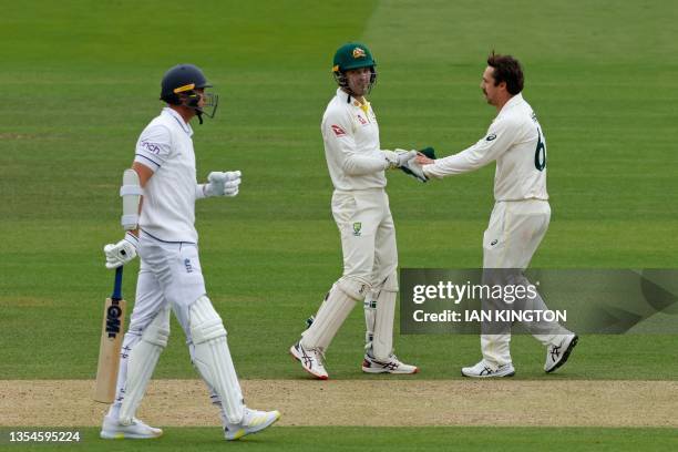 Australia's Travis Head celebrates with Australia's wicket keeper Alex Carey after taking the wicket of England's Stuart Broad on day three of the...