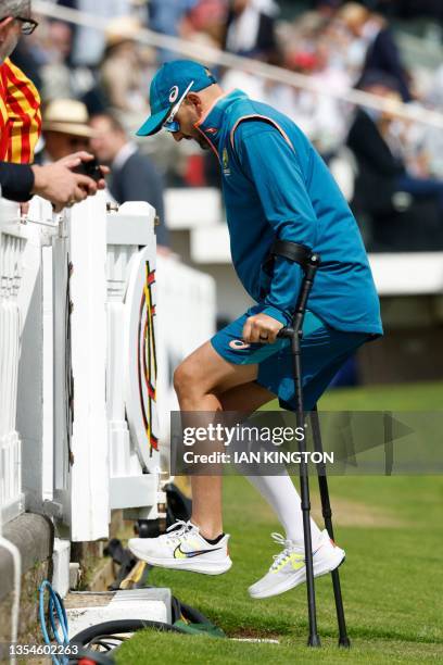 Australia's Nathan Lyon walks with crutches ahead of play on day three of the second Ashes cricket Test match between England and Australia at Lord's...