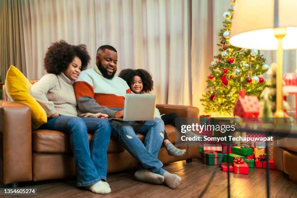 black african family enjoy time together while using phone for playing and video call,african american family gather to celebrate and enjoy traditional holiday dinner or lunch thanksgiving or christmas - virtual thanksgiving stock pictures, royalty-free photos & images