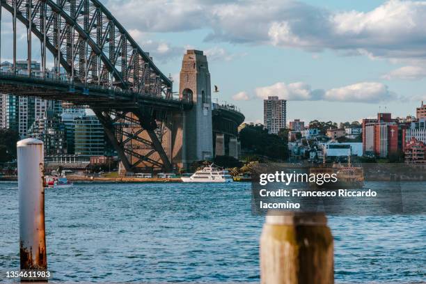 cityscape image of sydney, australia with harbor bridge and boats - sydney ferry stock-fotos und bilder