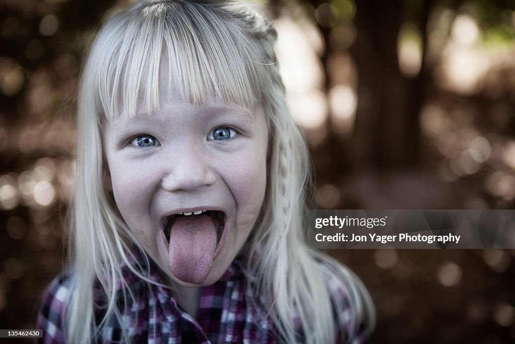 Young Girl Sticking Tongue Out High-Res Stock Photo - Getty Images