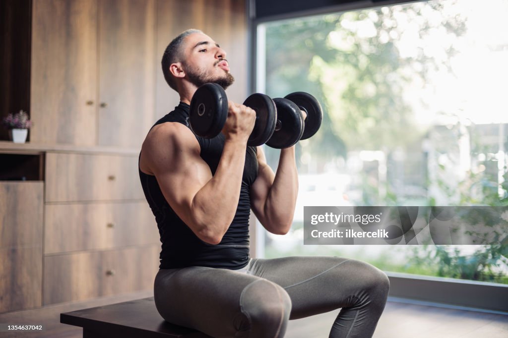 Muscular Athletic Young Man Training For Body Building At Home
