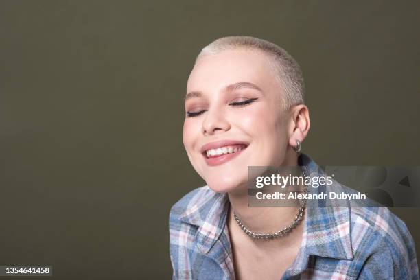 face of happy blonde woman man with short hipster hair on olive background in studio - eastern european 個照片及圖片檔