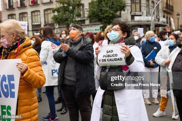 Woman holds a banner reading "SAD publico y de calidad", at a demonstration of social and health care professionals, on 21 November, 2021 in Madrid,...