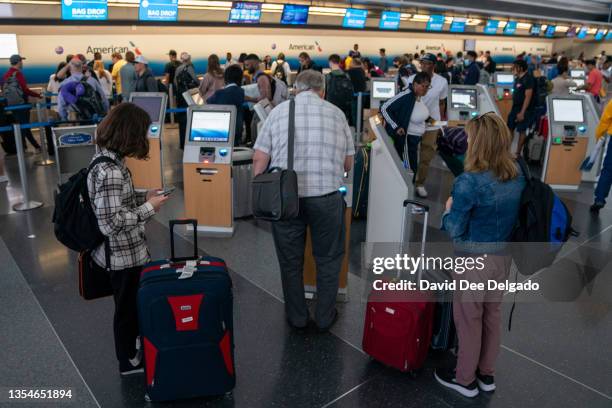 People checkin at the kiosk JFK International airport on June 30, 2023 in New York City.The number of Americans traveling by air for the Fourth of...