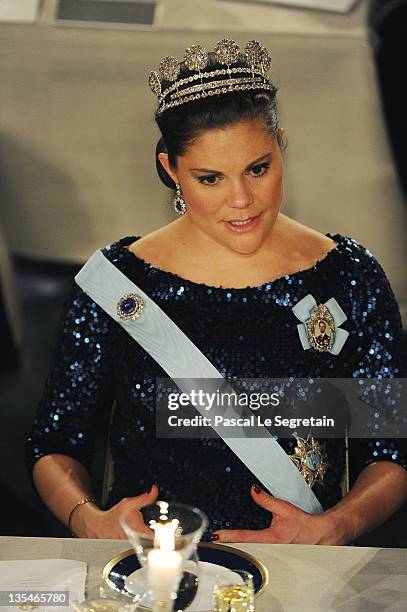 Crown Princess Victoria of Sweden touches her pregnant belly at the Nobel Prize Banquet at Stockholm City Hall on December 10, 2011 in Stockholm,...