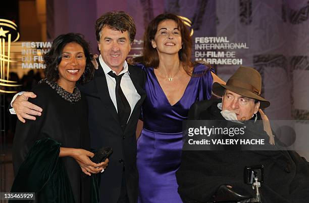 French actor Francois Cluzet and his wife Narjiss pose with French businessman Philippe Pozzo Di Borgo and his wife as they arrive at the 11th...