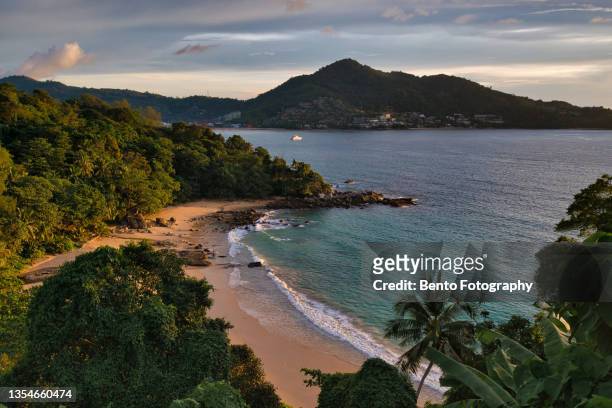 beautiful sand beach with tropical coconut palm tree and secret beach when sunset, phuket, thailand. - phuket stock pictures, royalty-free photos & images
