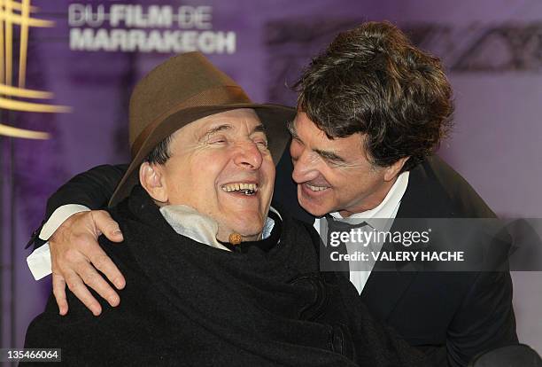 French actor Francois Cluzet poses with French businessman Philippe Pozzo Di Borgo as they arrive at the 11th Marrakech International Film Festival...