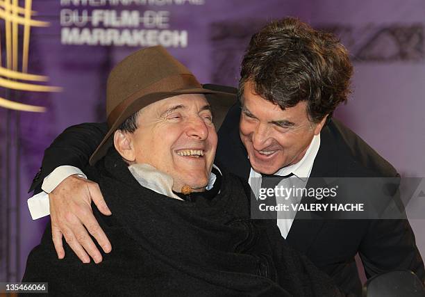 French actor Francois Cluzet poses with French businessman Philippe Pozzo Di Borgo as they arrive at the 11th Marrakech International Film Festival...