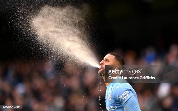 Kyle Walker of Manchester City blows out water after taking a drink prior to the Premier League match between Manchester City and Everton at Etihad...