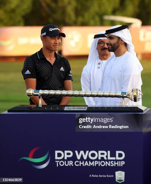 Collin Morikawa of the United States poses with the trophy after winning The DP World Tour Championship at Jumeirah Golf Estates on November 21, 2021...