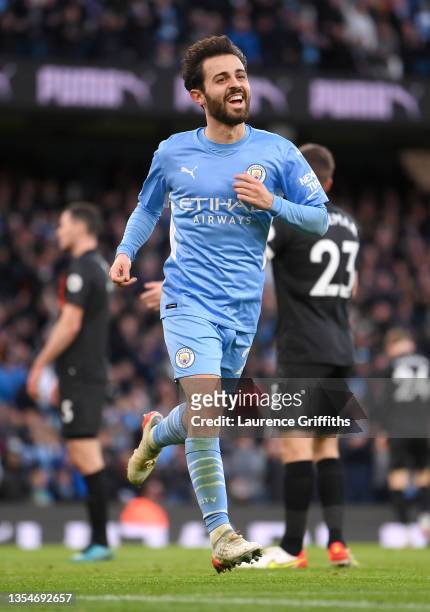 Bernardo Silva of Manchester City celebrates after scoring their side's third goal during the Premier League match between Manchester City and...