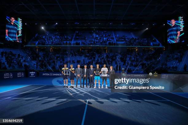 Nicolas Mahut and Pierre-Hugues Herbert of France pose for a photograph with the trophy following victory along with Joe Salisbury of Great Britain...