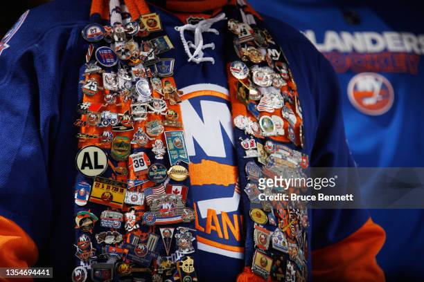 Fan shows off his pins during the game between the New York Islanders and the Calgary Flames at the UBS Arena on November 20, 2021 in Elmont, New...