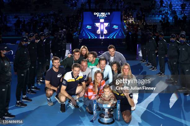 Pierre-Hugues Herbert and Nicolas Mahut of France pose with the trophy and members of their family after the Men's Doubles final match between...