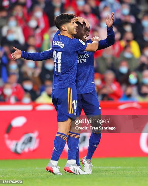 Ferland Mendy of Real Madrid celebrates after scoring their side's fourth goal with Marco Asensio during the La Liga Santander match between Granada...