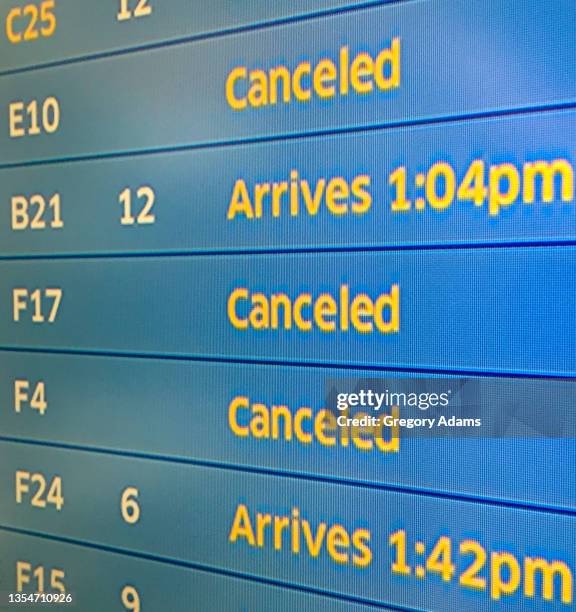 status board indicating canceled flights in chicago - cancelled fotografías e imágenes de stock