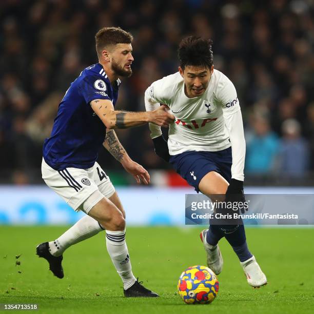 Heung-Min Son of Tottenham Hotspur in action with Mateusz Klich of Leeds United during the Premier League match between Tottenham Hotspur and Leeds...