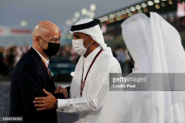 Stefano Domenicali, CEO of the Formula One Group, shakes hands with Qatar Prime Minister Khalid bin Khalifa bin Abdulaziz Al Thani on the grid before...