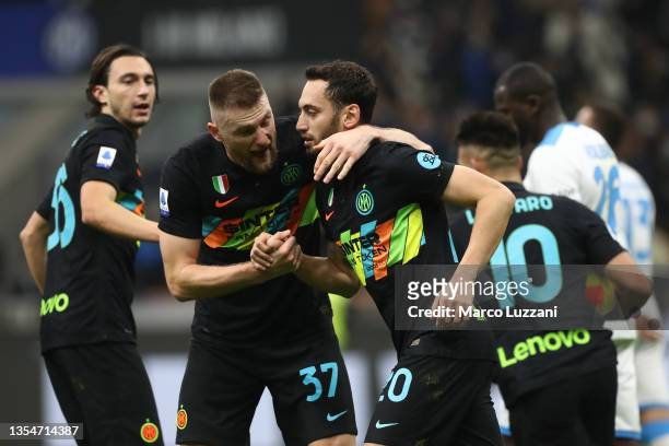 Hakan Calhanoglu of FC Internazionale celebrates after scoring their side's first goal with Milan Skriniar during the Serie A match between FC...