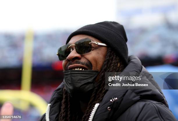 Former Buffalo Bills player Marshawn Lynch on the field before the against the Indianapolis Colts at Highmark Stadium on November 21, 2021 in Orchard...