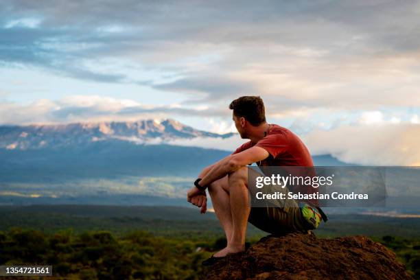 enjoyment in the nature - moment of adoration of mt. kilimanjaro. - mt kilimanjaro stockfoto's en -beelden