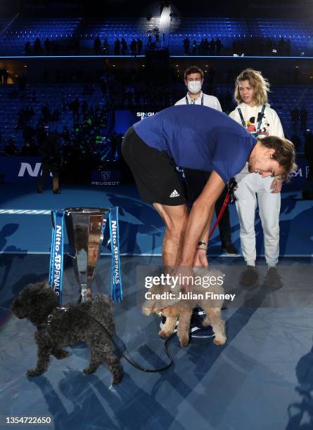 Alexander Zverev of Germany strokes his dogs alongside the trophy following victory in the Men's Single's Final between Alexander Zverev of Germany...