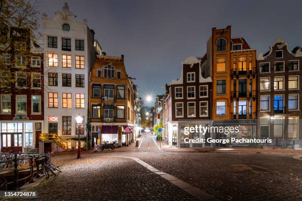 amsterdam skyline with traditional dutch houses, holland, netherlands at night - skyline amsterdam stock pictures, royalty-free photos & images