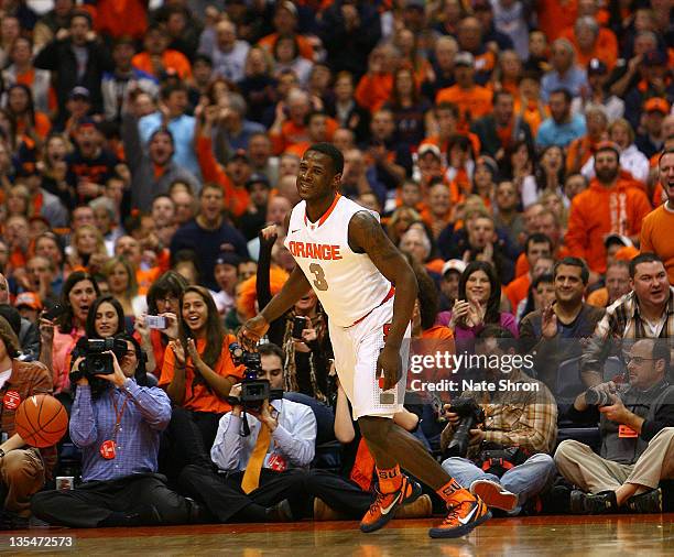 Dion Waiters of the Syracuse Orange runs on the court as he smiles after a basket against the George Washington Colonials during the game at the...