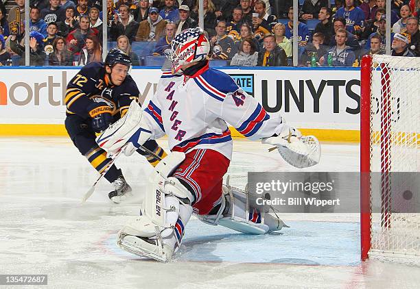 Luke Adam of the Buffalo Sabres tries but can not tip the puck past goaltender Martin Biron of the New York Rangers at First Niagara Center on...